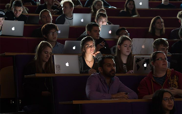 Students with laptops in a lecture theatre