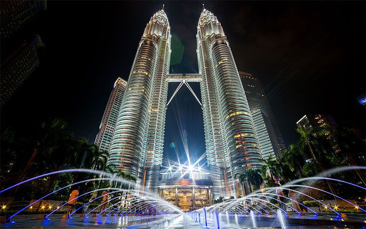 Petronas Towers lit up at night in Malaysia