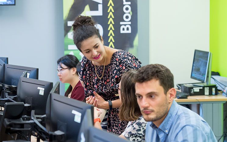A lecturer speaks to students in the Bloomberg computer lab.