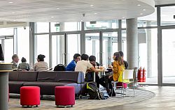 Students and staff relaxing in the social space