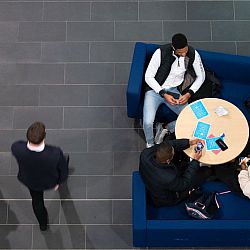 students sit around a table studying in jubilee building