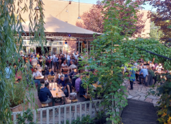 Conference attendees socializing in beer garden at funky Berlin venue, Festsaal Kreuzberg