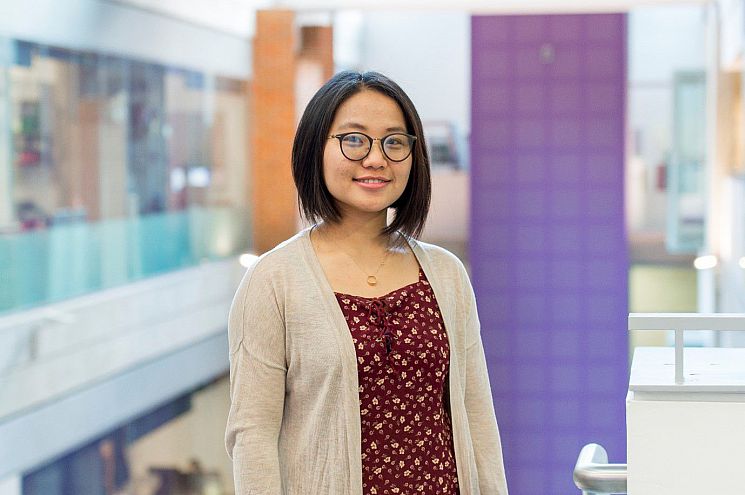 Sussex MBA alumna student in Jubilee Building smiling