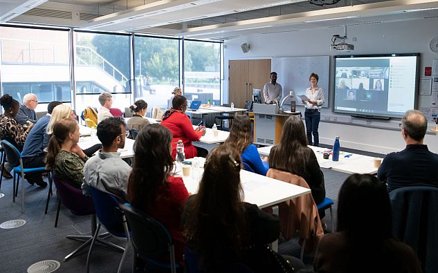 Workshop participants sitting in seminar room facing speaker Dr Annemie Maertens