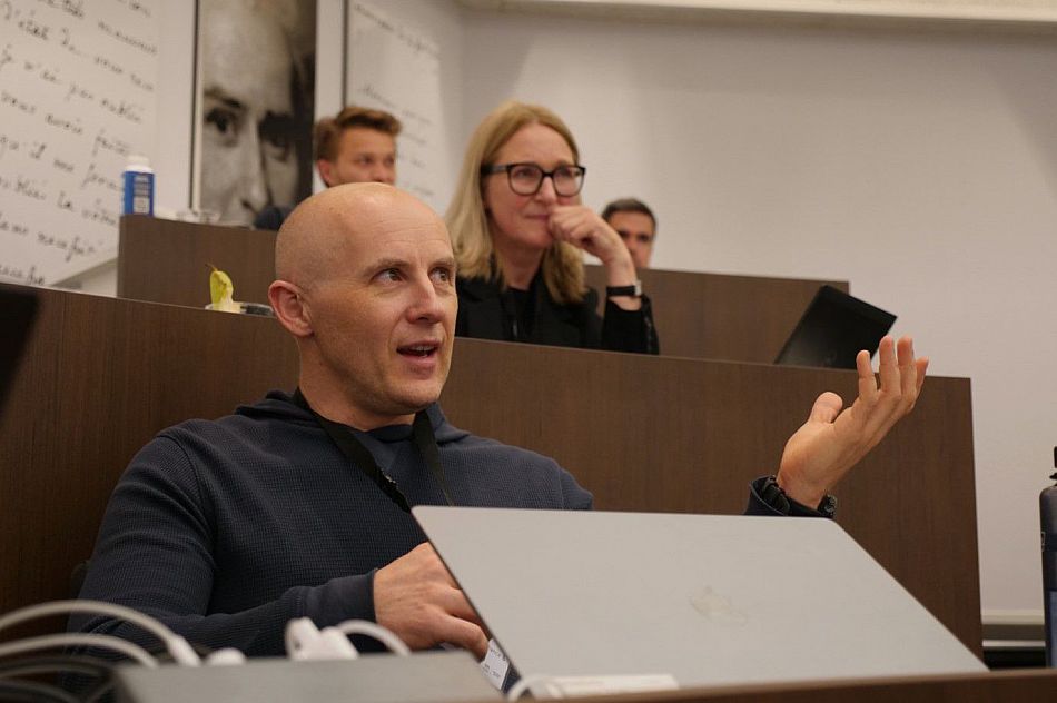 Grigory Vilkov gesturing and speaking during the presentation