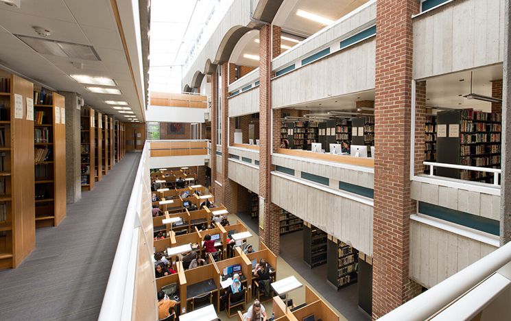 An inside view of the University of Sussex Library from the middle floor looking down to the ground floor from above