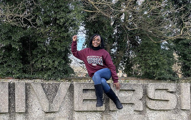 Thokozani Makuyana sat atop Uni of Sussex sign