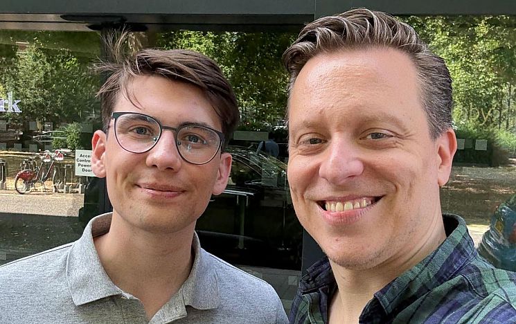 Two men smiling, a mentee with his mentor