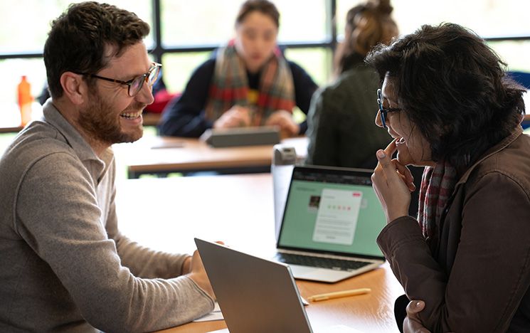 Two MA Migration and Global Development students in a seminar room