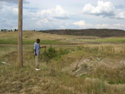 Dr. Tsiokane indicates roadside tree planting for gully control