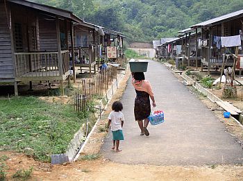 Today women have to find and bring water back from the river to their resettlement site