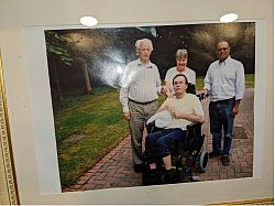 Photograph of four people together smiling for photograph