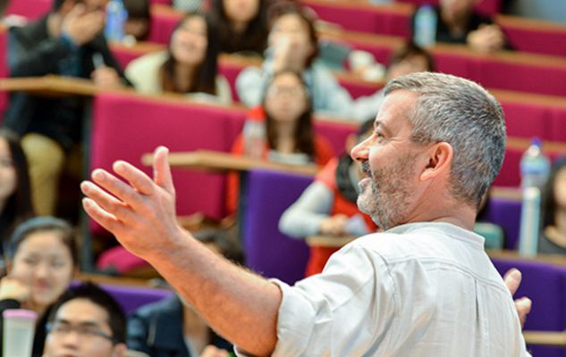 Lecturer teaching in a lecture theatre at the University of Sussex