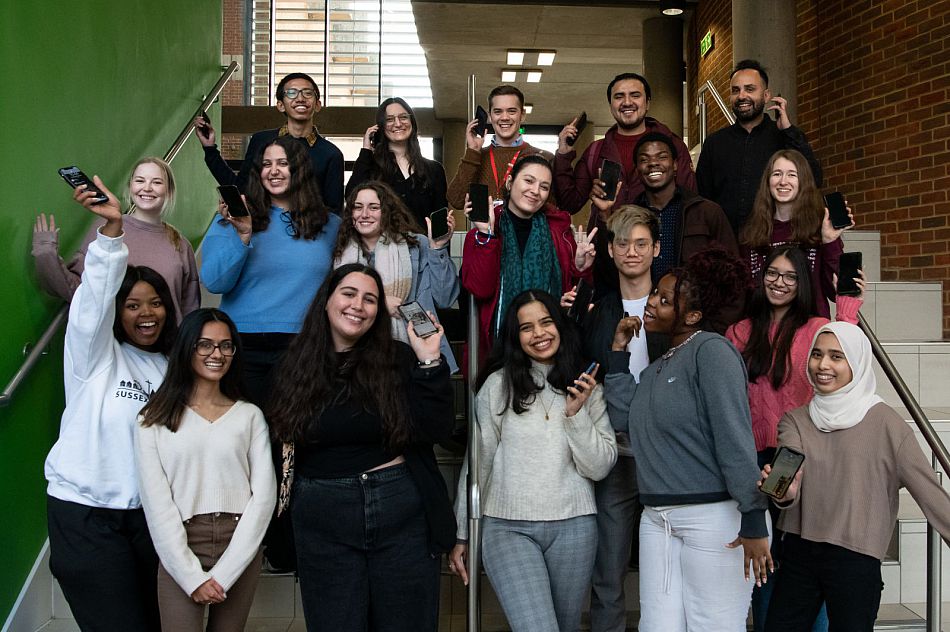 A group of student callers hold up phones