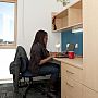 A student at her desk in a Northfield room