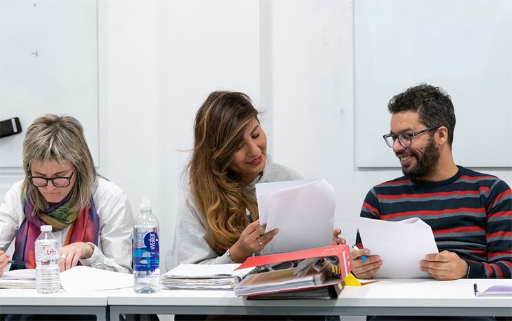 Three students working at a table