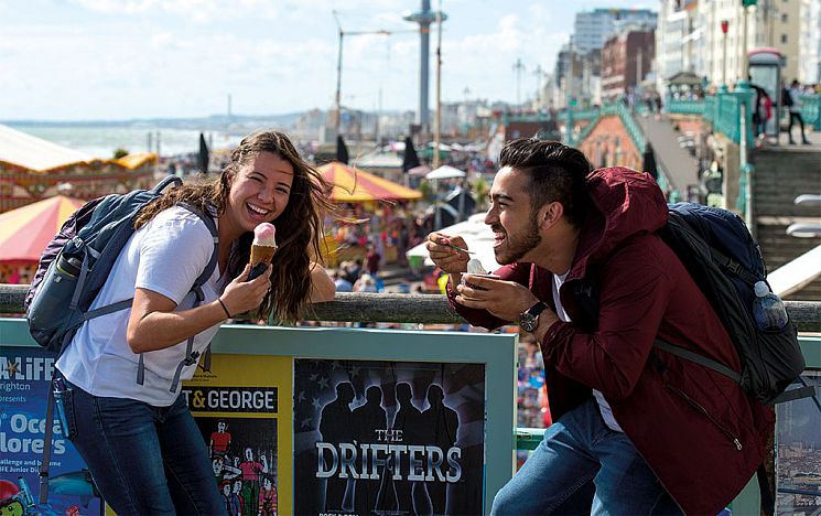students on Brighton pier enjoying ice cream