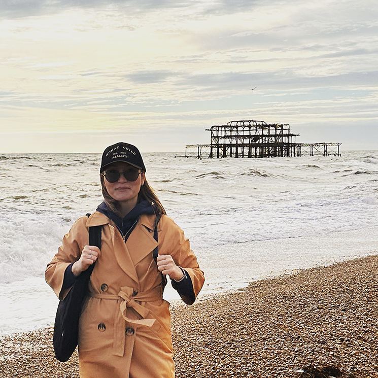 Aliya stood on the beach, Brighton west pier in the background