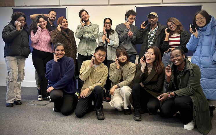 The call campaign team holding mobile phones