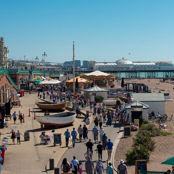 Busy seafront with pier in background