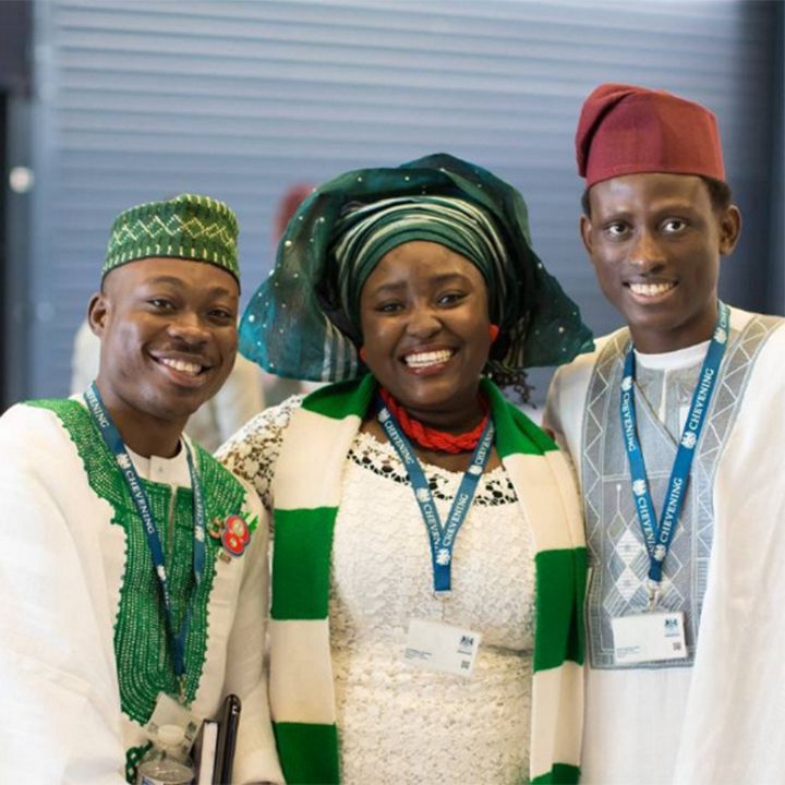 Three students smiling