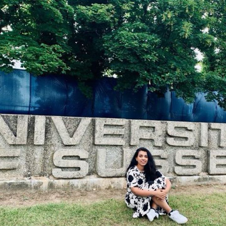 Narmeen posed in front of the University of Sussex sign