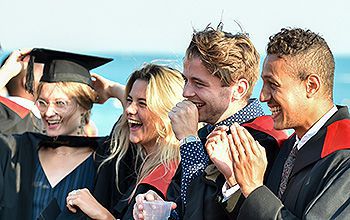 Students celebrating their graduation on Brighton seafront