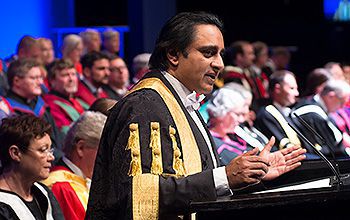 The Chancellor of Sussex stands at the lectern during a ceremony