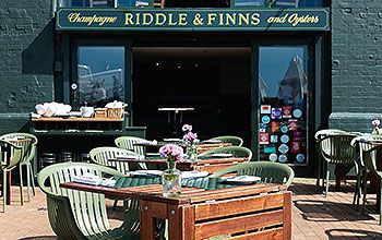The outside of Riddle and Finns, a seafood restaurant facing Brighton beach