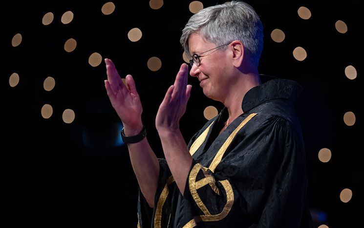 Vice Chancellor Professor Sasha Rosneil clapping on stage.