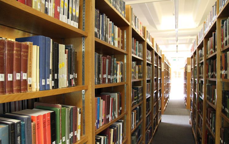 Rows of shelves in Library containing books