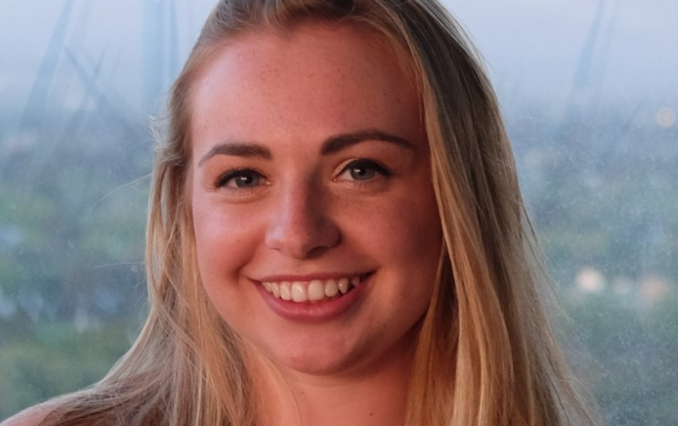 A portrait photo of Bryony, a student volunteer for the Law Clinic, in front of a window