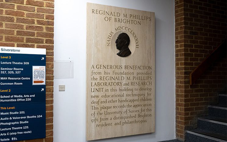 Marble plaque hanging in Silverstone building, dedicated to Reginald Moses Phillips CBE Hon LLD (1888-1977), a Brighton businessman and philanthropist.