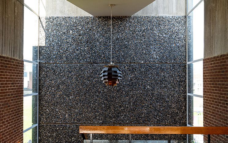 The flint wall in the main stairwell of Falmer House.