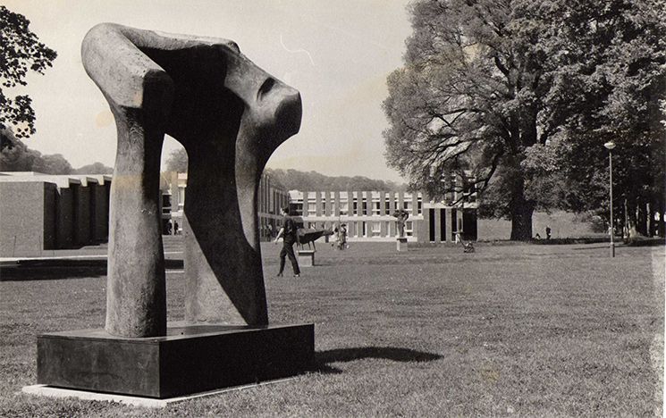 Black and white photo of a bronze sculpture of a torso by Henry Moore, taken by Robert Cahn.