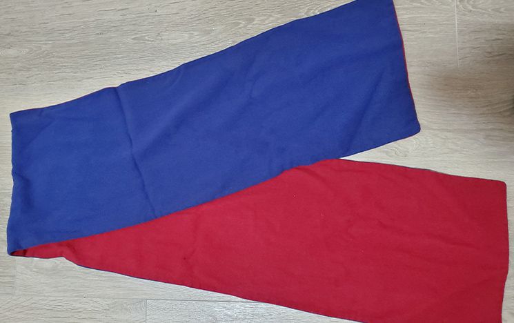 A University of Sussex scarf, one side red and the other blue, from 1962.