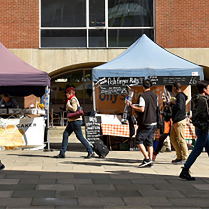 Stalls in Falmer courtyard with people walking around
