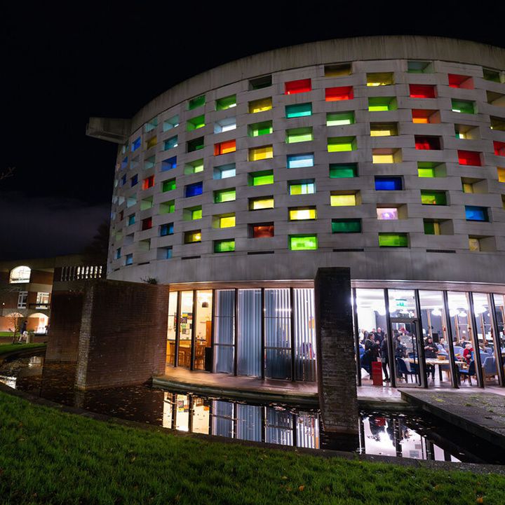 Circular building coloured windows at night