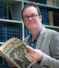David Hendy reading an old copy of the Radio Times in his study