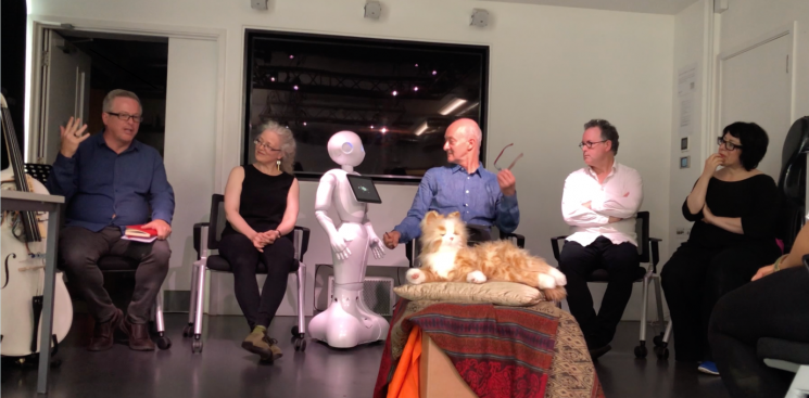 Post performance panel discussion. Left to right: robot cello, Ron Chrisley, Evelyn Ficarra, Pepper the robot, Nick Till, Anton Lukoszevieze, Loré Lixenberg. Foreground: Lou-Lou Louise the robot cat.