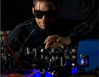 researcher adjusting optics