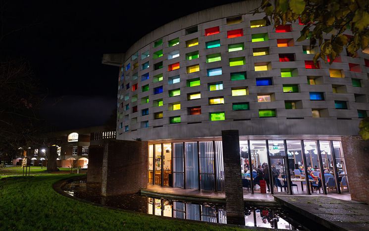 Round building with stained glass windows at night