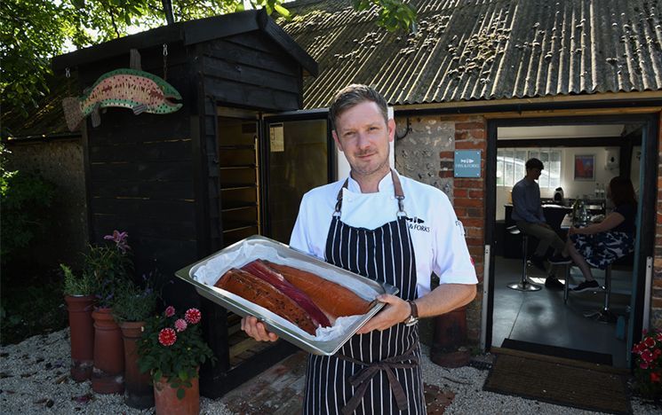 Sussex's Executive Chef Michael King holding a tray of freshly prepared fish