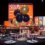 n example of the table set-up for an awards event at the ACCA, including black and gold balloons and a spread of food