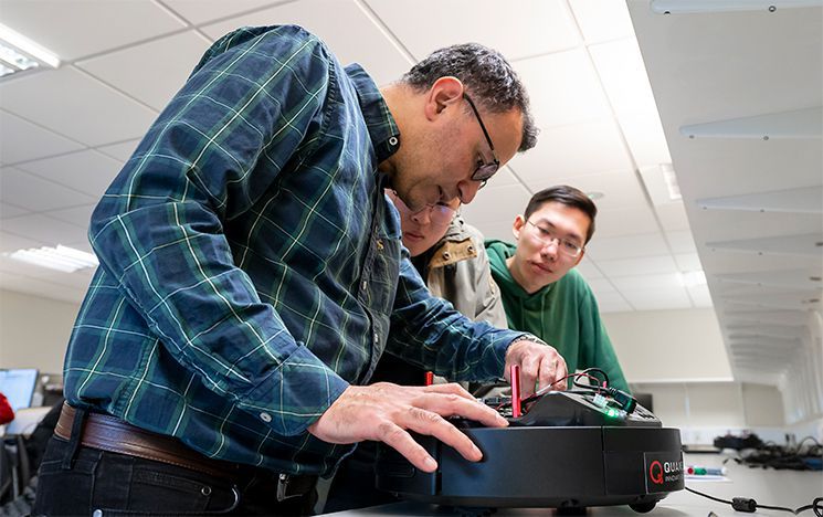Students working with a Quanser QBot 3 robot