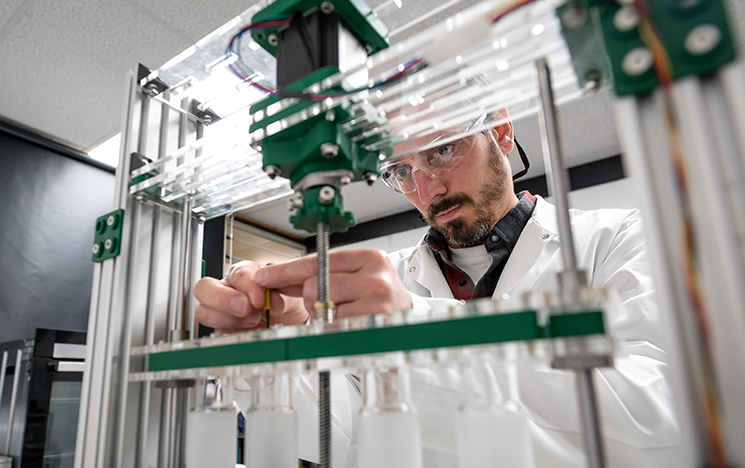 A researcher looking at equipment in the thermal fluid lab