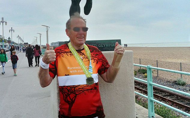 John Mason in front of Steve Ovet statue in Brighton