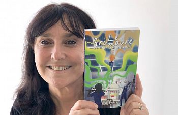 Sussex alumna Elaine Bousfield holding a book