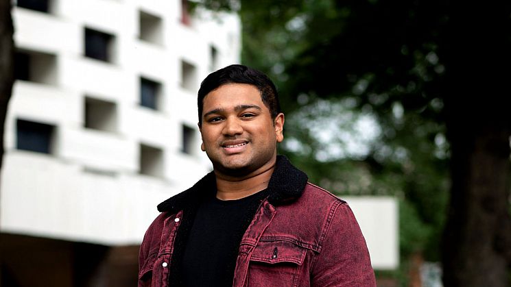 Adarsh standing in front of the Meeting House at Sussex