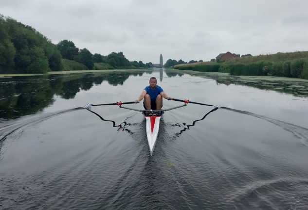 Alumnus Tom Mumford rowing boat on river